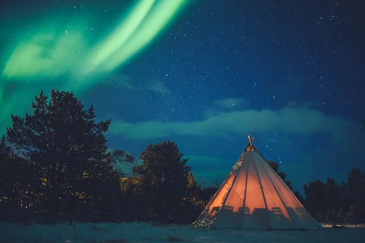 Green aurora over a campsite in Tromsø, Norway