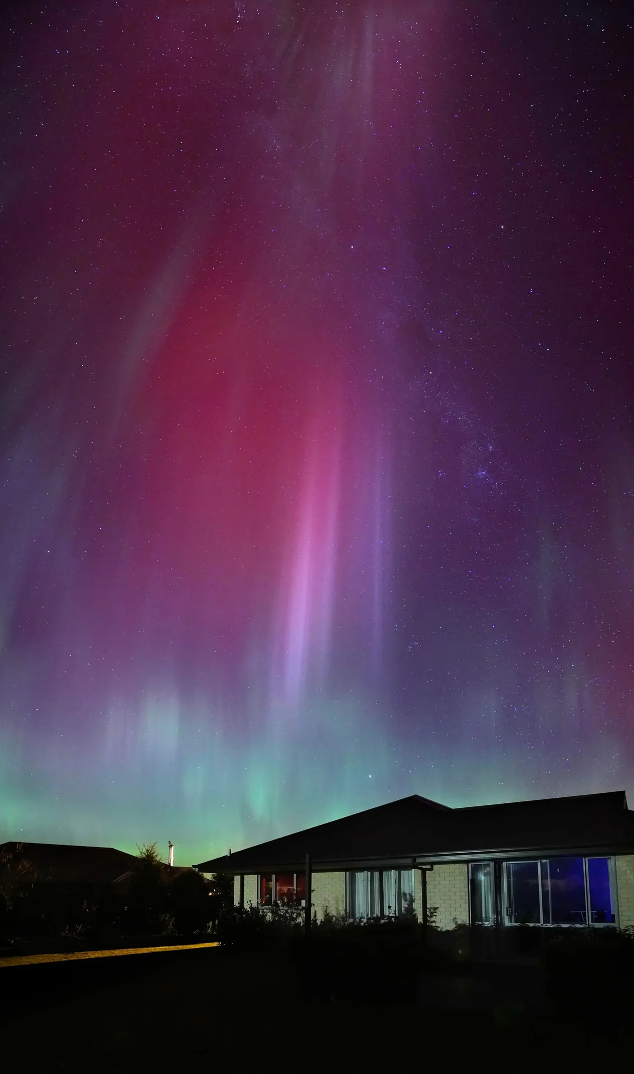 A stunning aurora australis illuminates the night sky above a house in Leeston, New Zealand.