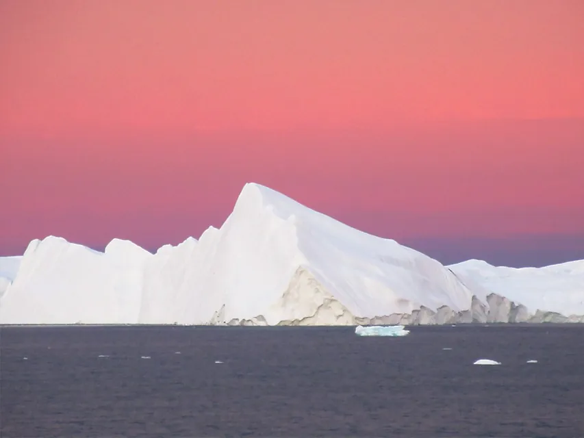 The sun rises over the Ilulissat Icefjord in Disko Bay near Ilulissat, Greenland