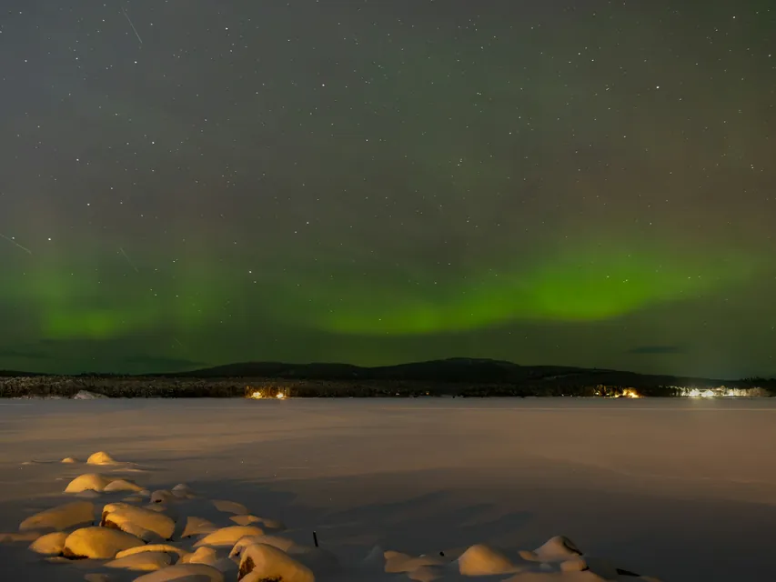 The aurora borealis makes an appearance on a cold November night over the frozen Lake Inari in northern Finland