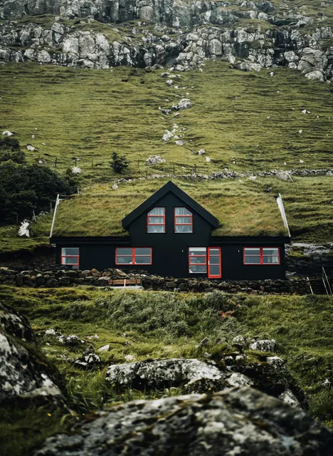 Traditional Timber House on Steep Slope in Mountains