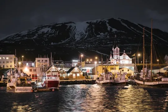 Husavik port with welcoming lights in late evening