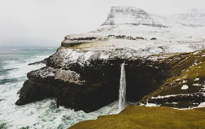The famous Múlafossur waterfall plunges directly into the ocean at Gásadalur