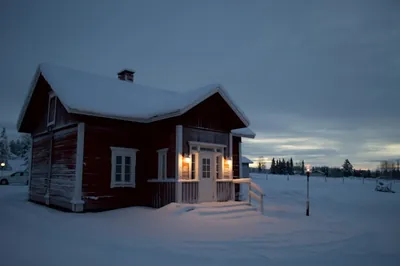 A wooden cabin in a snowy landscape near Kierinki, Finland